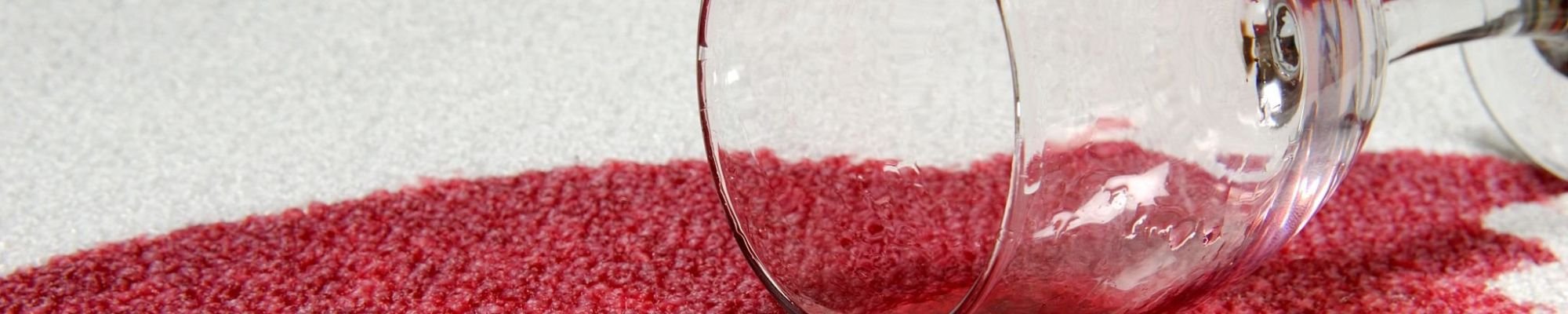 A glass of red wine spilled on white carpet from The Family Floor Store in Ellsworth, ME