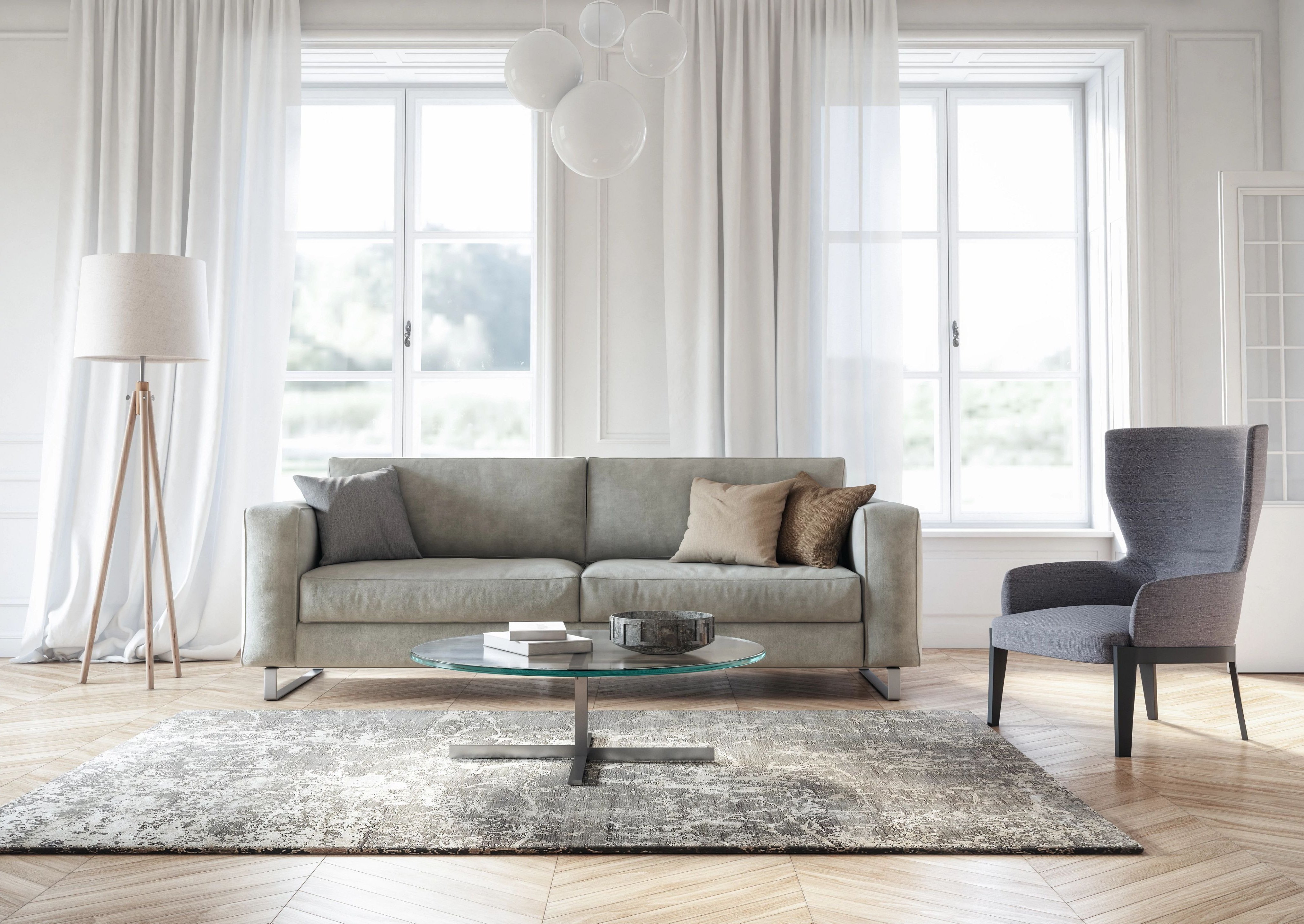 Bright living room with gray couch, hardwood flooring and a large gray area rug from The Family Floor Store in Ellsworth, ME