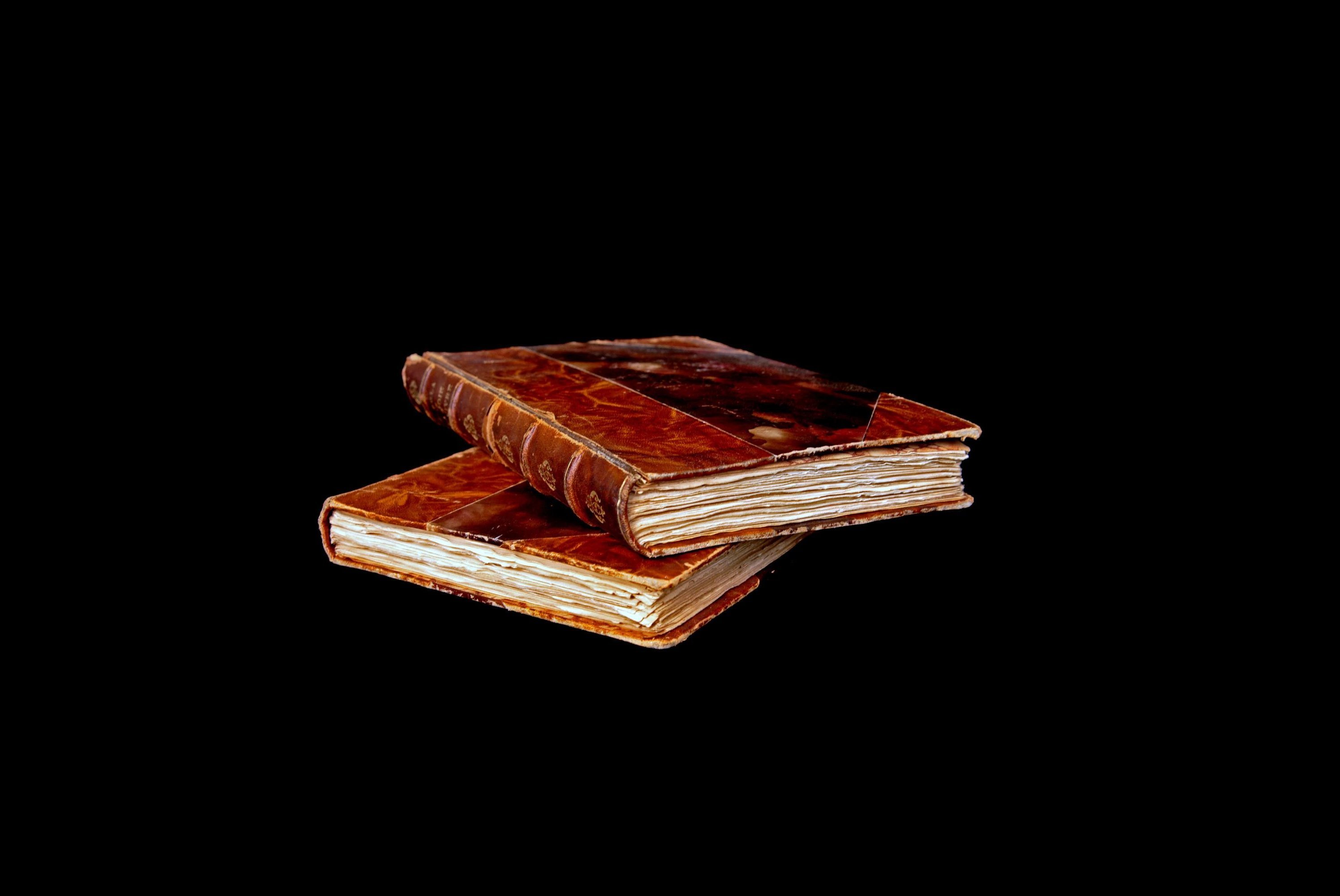 Two books stacked on top of each other - Learn more about the history of flooring from The Family Floor Store in Ellsworth, ME