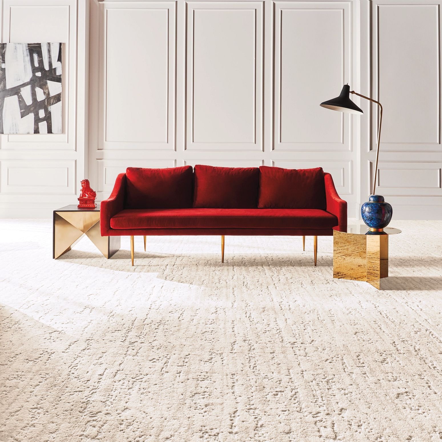 Bright living room with a red velvet couch and beige textured carpet from The Family Floor Store in Ellsworth, ME