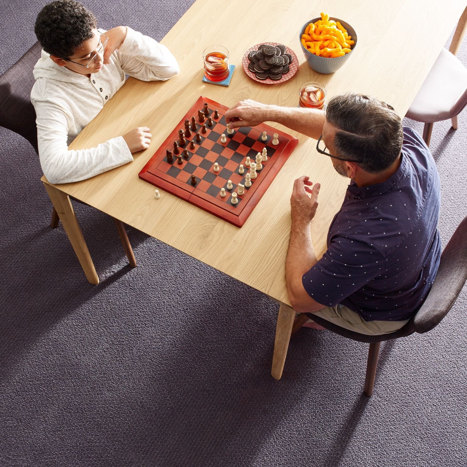 Two people playing chess - The Family Floor Store in Ellsworth, ME