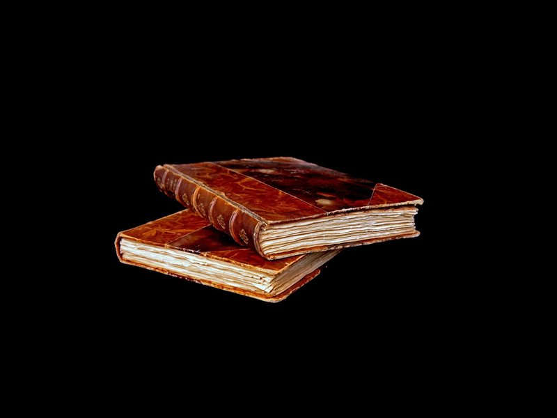 Two books stacked on top of each other - Learn more about the history of flooring from The Family Floor Store in Ellsworth, ME