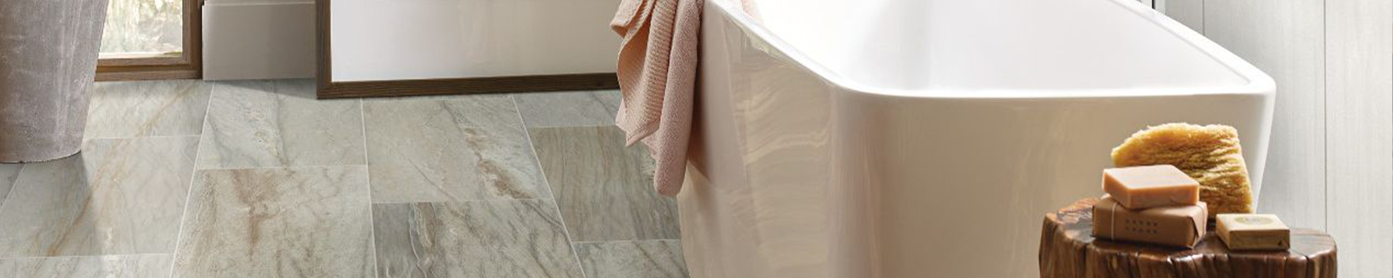 bathtub and stool with soap on tile floor from The Family Floor Store in Ellsworth, ME